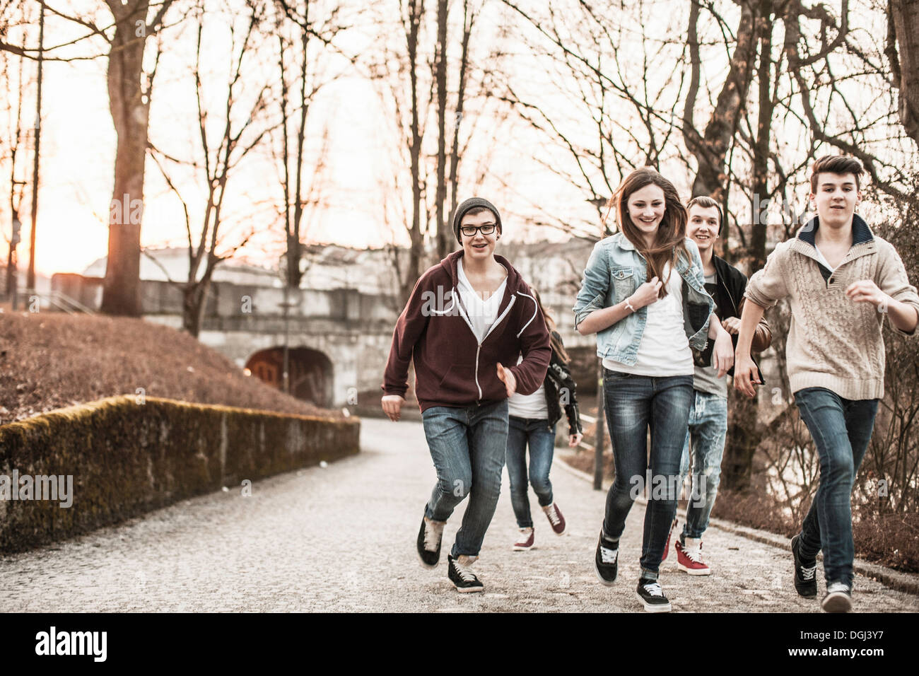 Five teenagers running through park Stock Photo Alamy