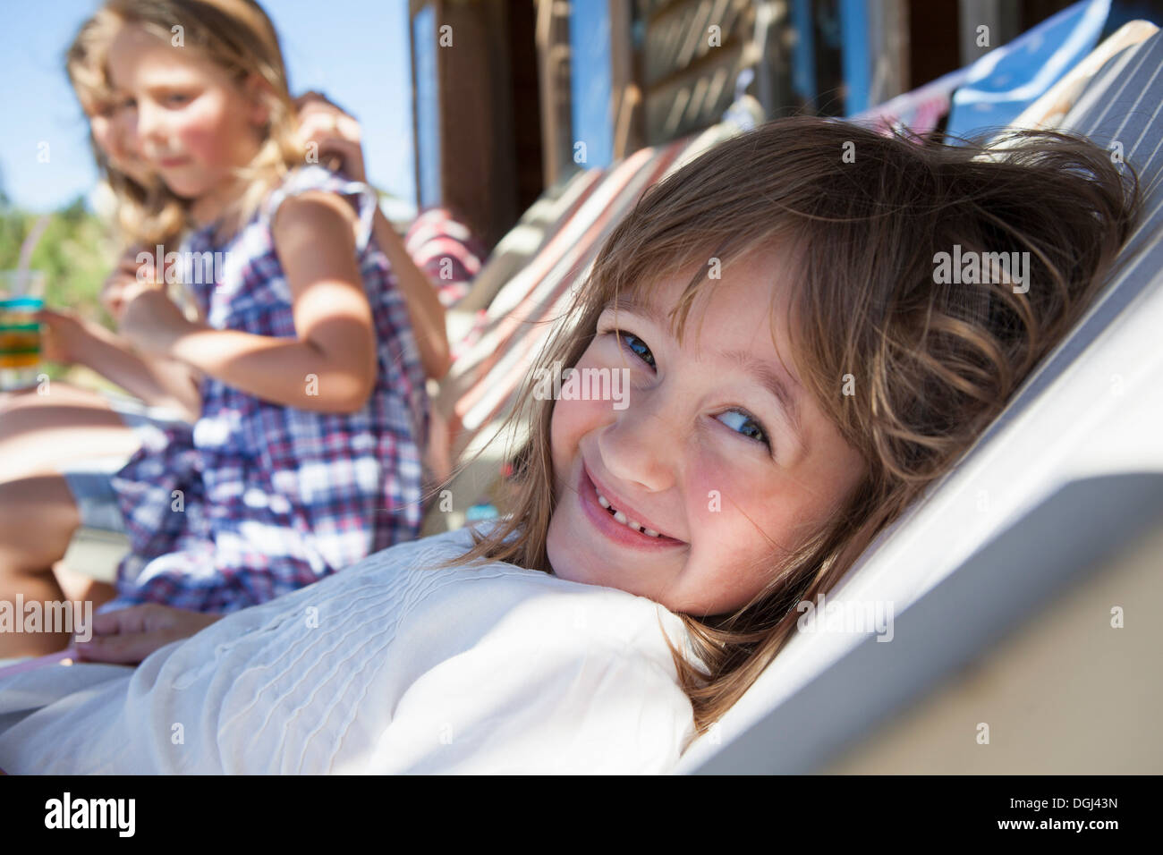 Girl relaxing in shade in summer Stock Photo