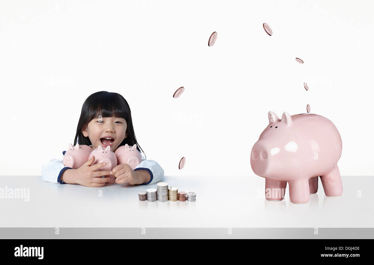 a girl holding several piggy banks Stock Photo - Alamy