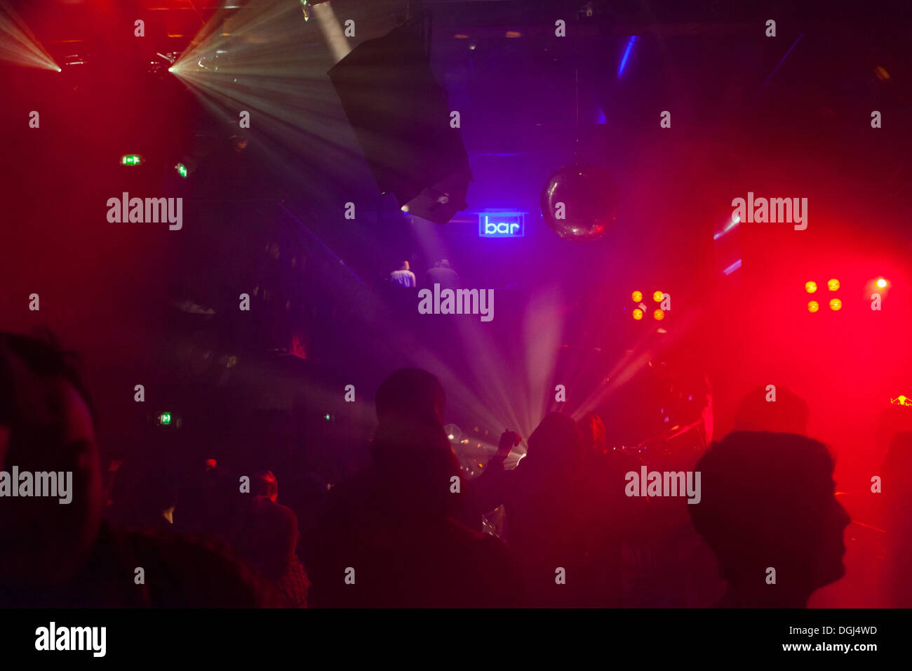 Nightclub scene with people dancing, disco ball, lighting equipment Stock Photo