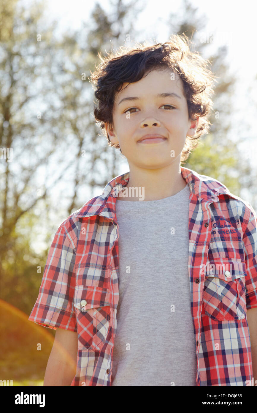 Boy wearing checked shirt in park Stock Photo Alamy