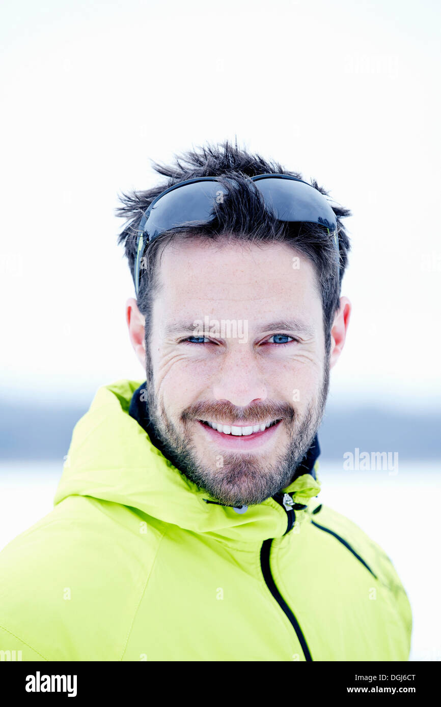 Man with sunglasses in snow field Stock Photo
