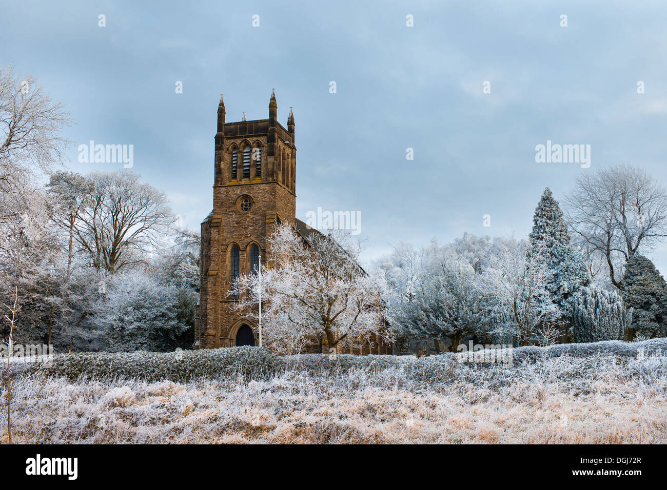 The church of St. Peter at Copt Oak surrounded by trees covered in hoar frost. Stock Photo