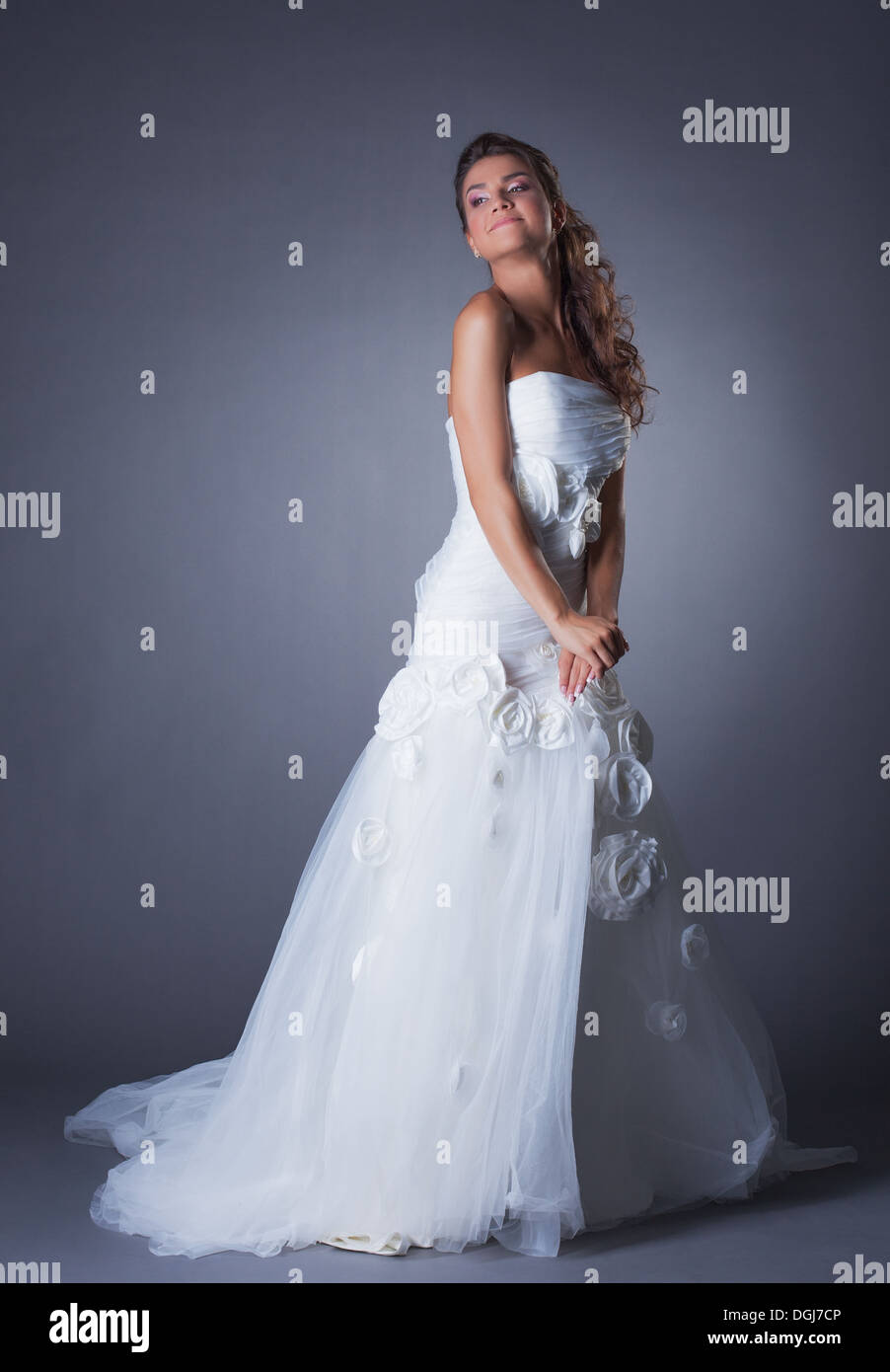 Dreamy brunette posing in elegant wedding dress Stock Photo - Alamy