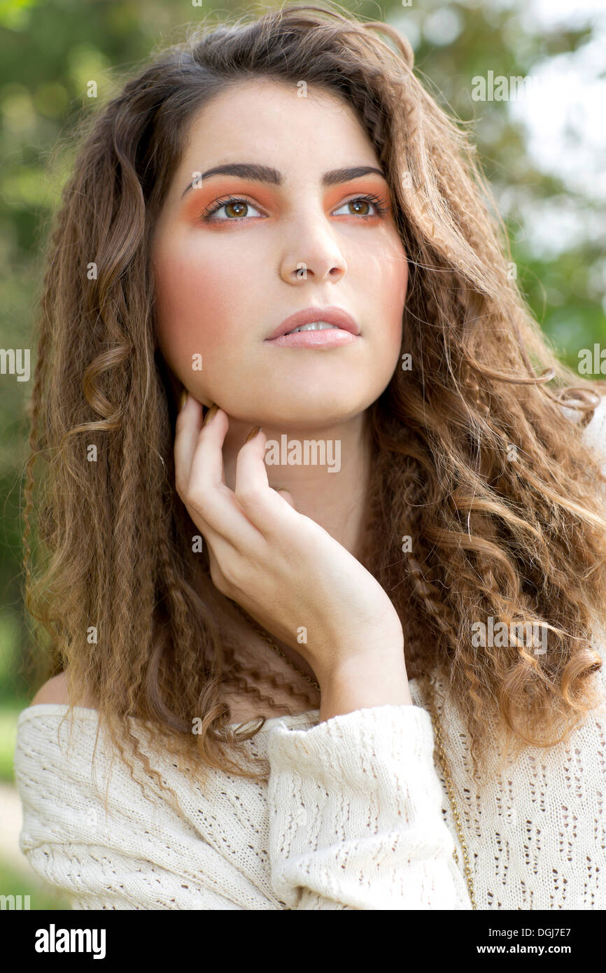 Young woman wearing a white sweater, portrait, outdoors Stock Photo