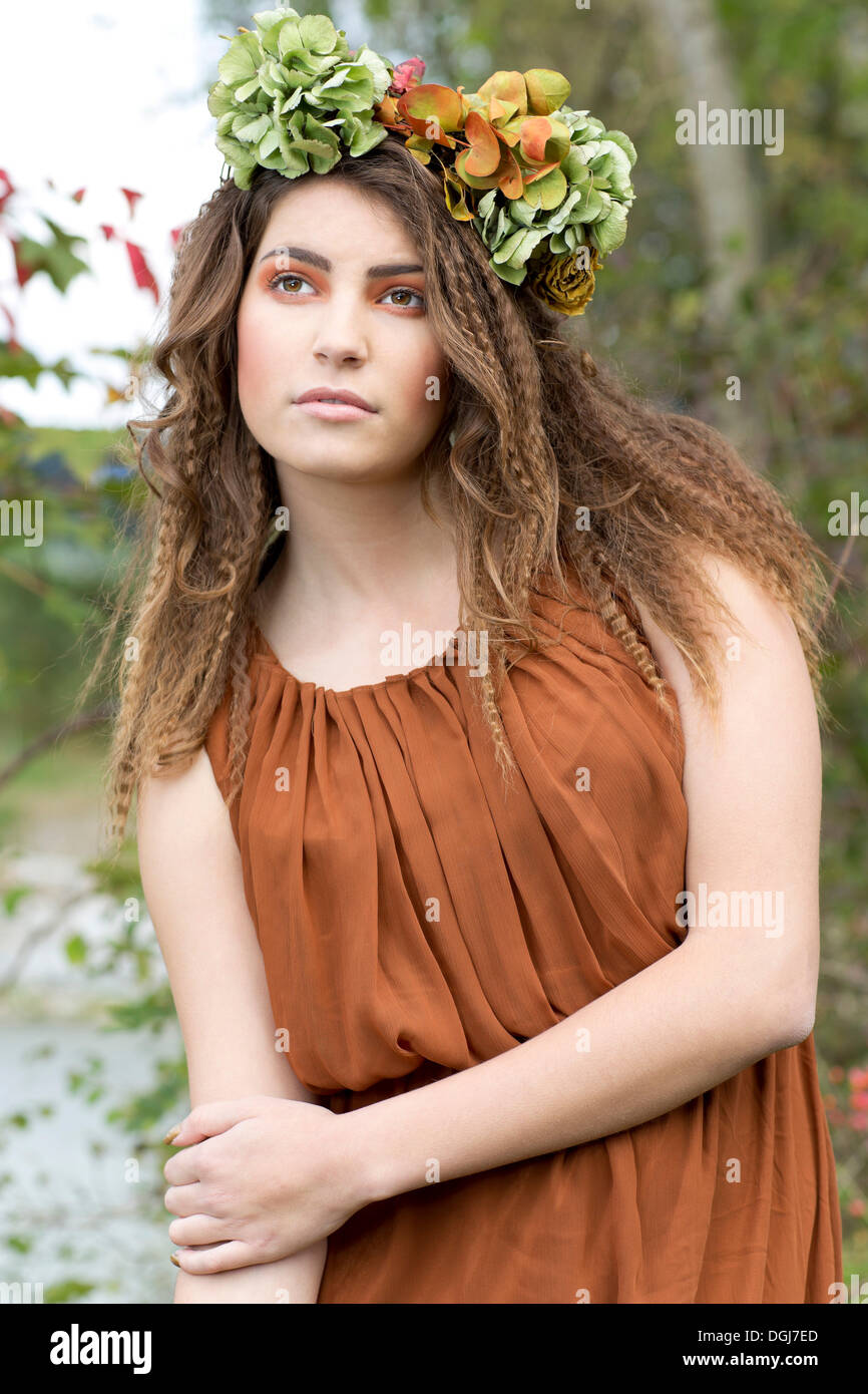 Young woman with a flowal wreath in her hair, outdoors Stock Photo
