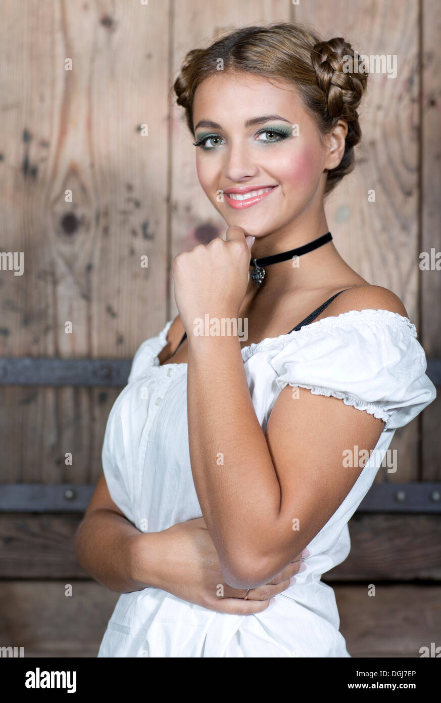 Young smiling woman wearing a white dirndl top, portrait, dirndl look Stock Photo
