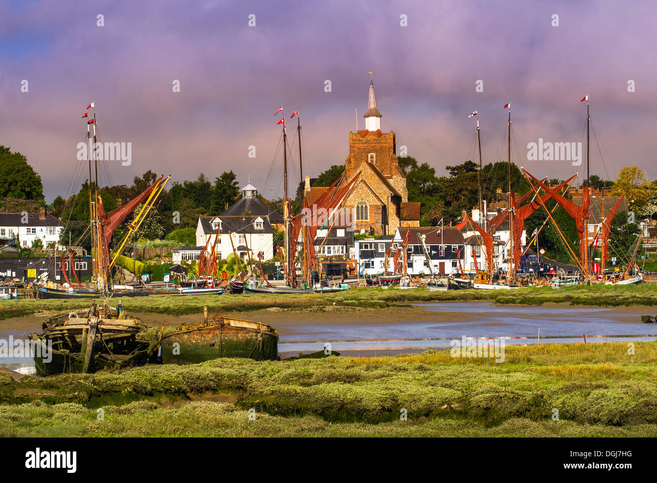 View of Maldon in Essex with several Thames sailing barges at the quay and the remains of two more in the mud of the estuary. Stock Photo