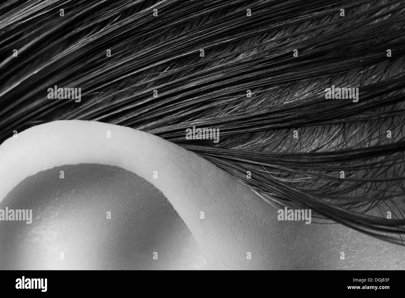 Close up view of a womans ear and hairline. Stock Photo