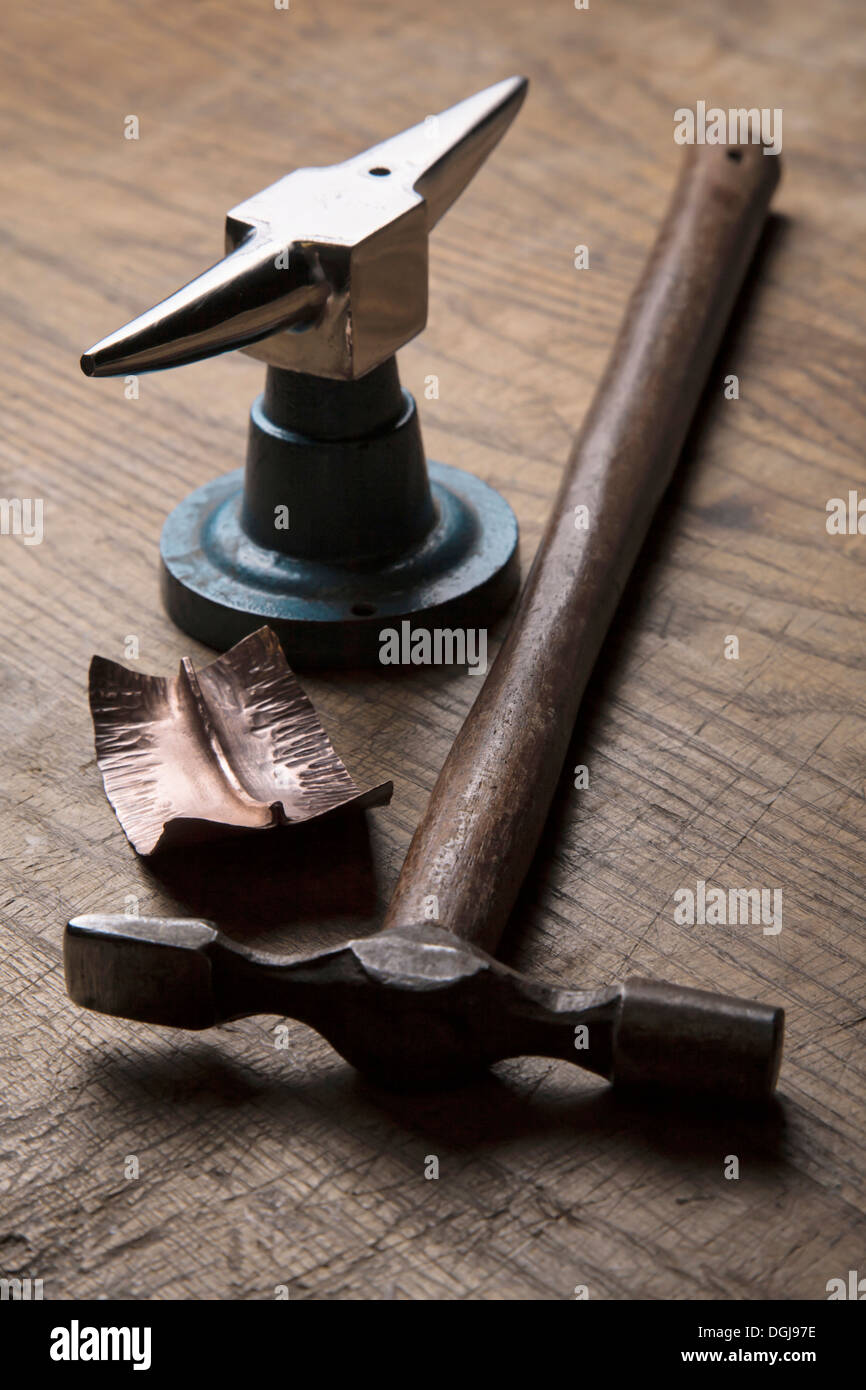 Metal forming tools and forged copper work. Stock Photo