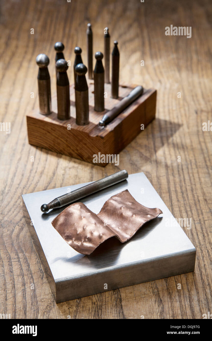 Metal doming punches and copper chased work. Stock Photo