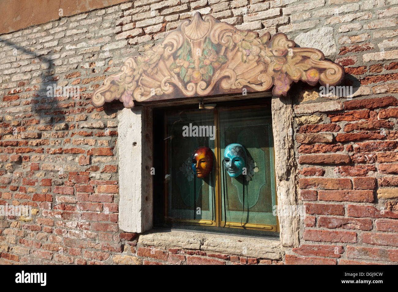 Masks on a shuttered window in Venice. Stock Photo
