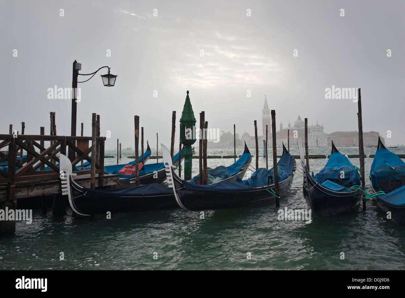 Gondolas moored in the Lagoon on a misty morning in Venice. Stock Photo