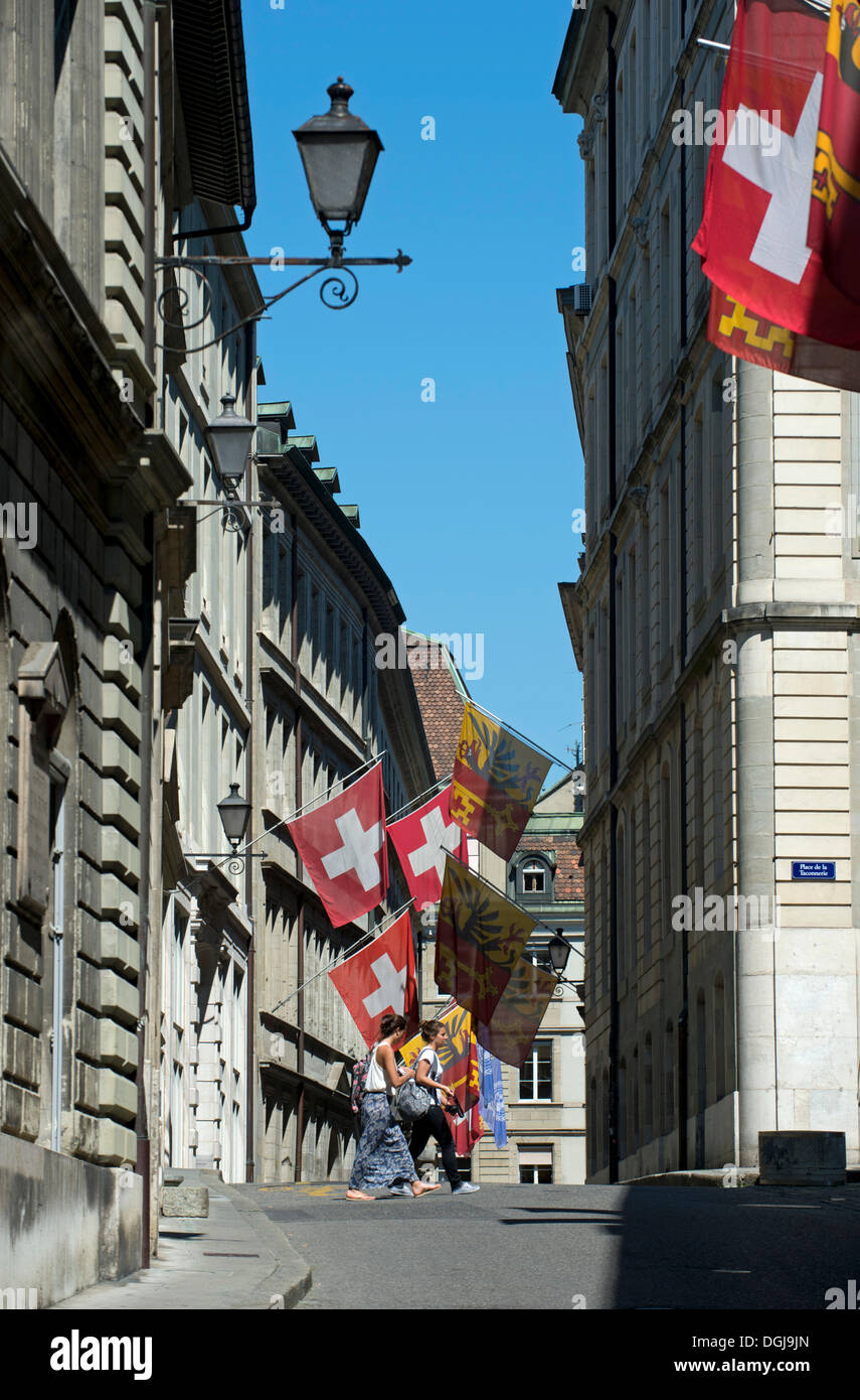 Flags of Switzerland and the Canton of Geneva in the Rathausgasse lane or Rue de l'Hôtel de Ville, in the old town of Geneva Stock Photo