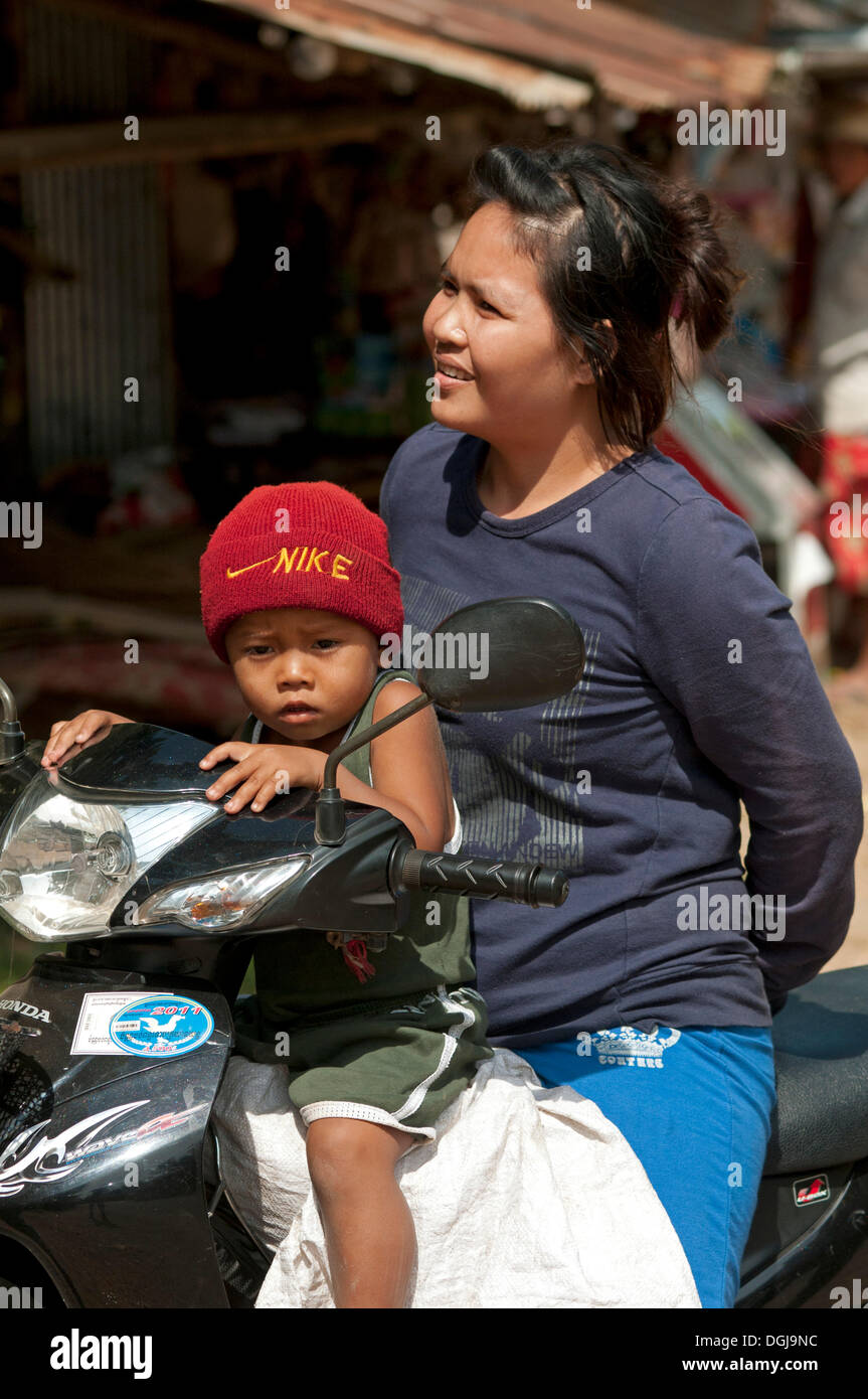 Woman and child with Nike hat on a motorcycle, Battambang, Cambodia,  Southeast Asia Stock Photo - Alamy