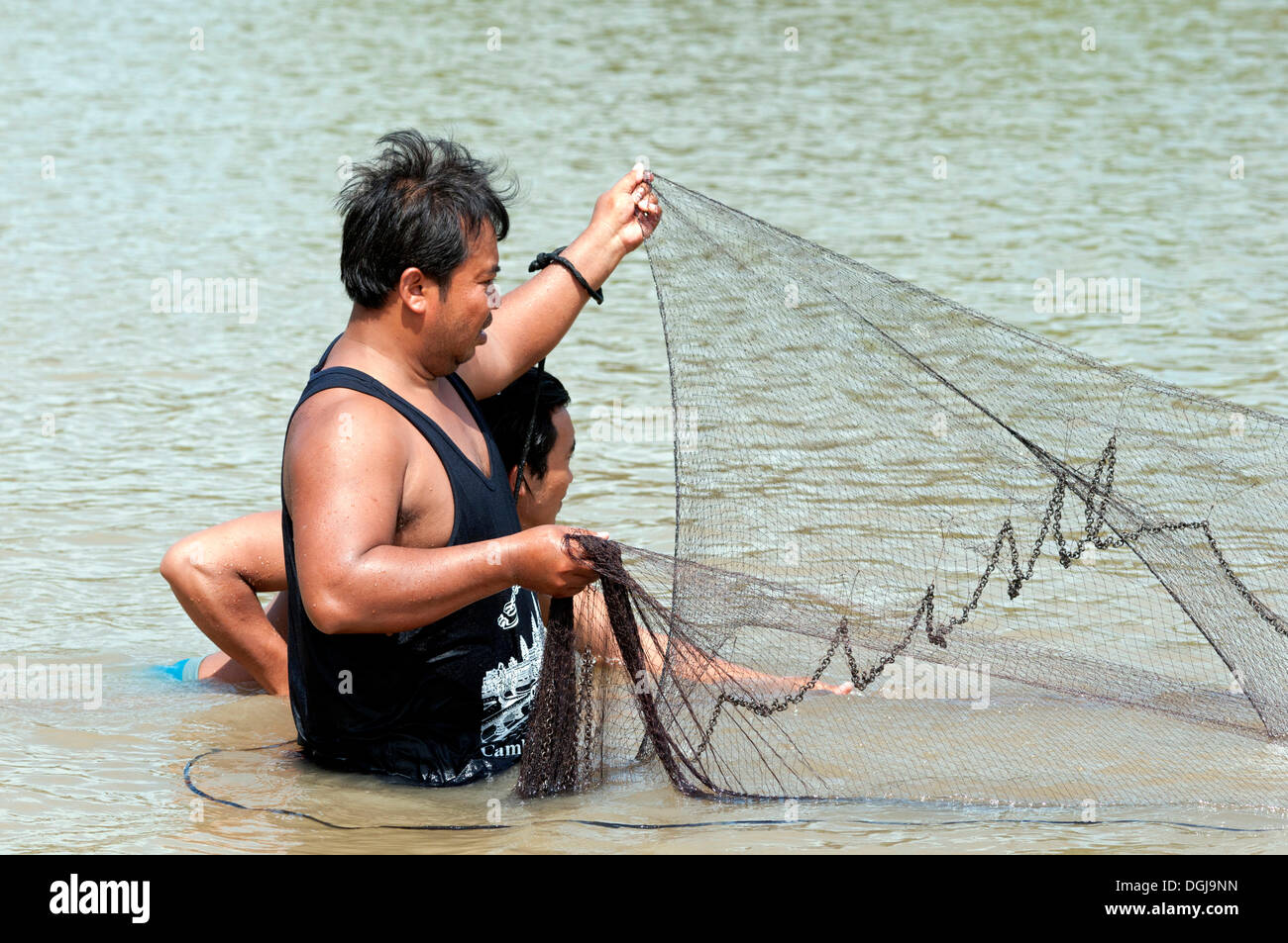 Fishermen putting out a fishing net in the Sangkae river
