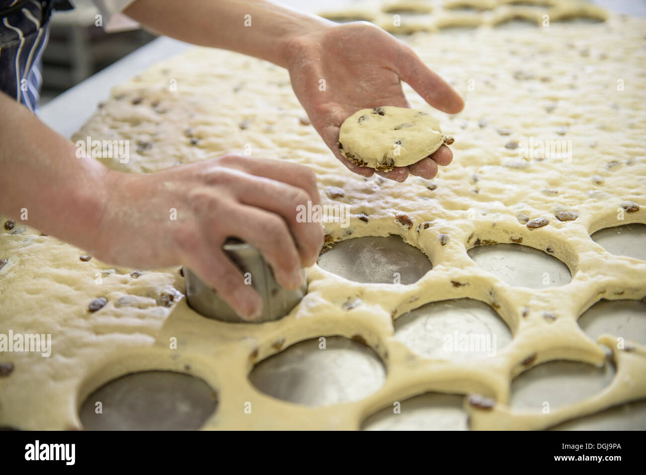 Baker cutting out fruit scones, close up Stock Photo