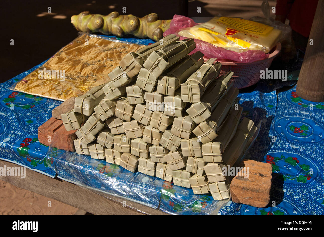 Palm sugar packed in palm leaves for sale at a market stall, Siem Reap