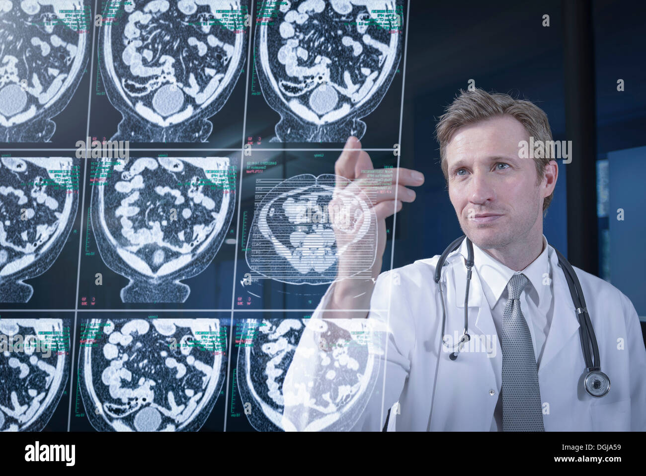 Doctor looking at computed tomography (CT) scans on screen Stock Photo