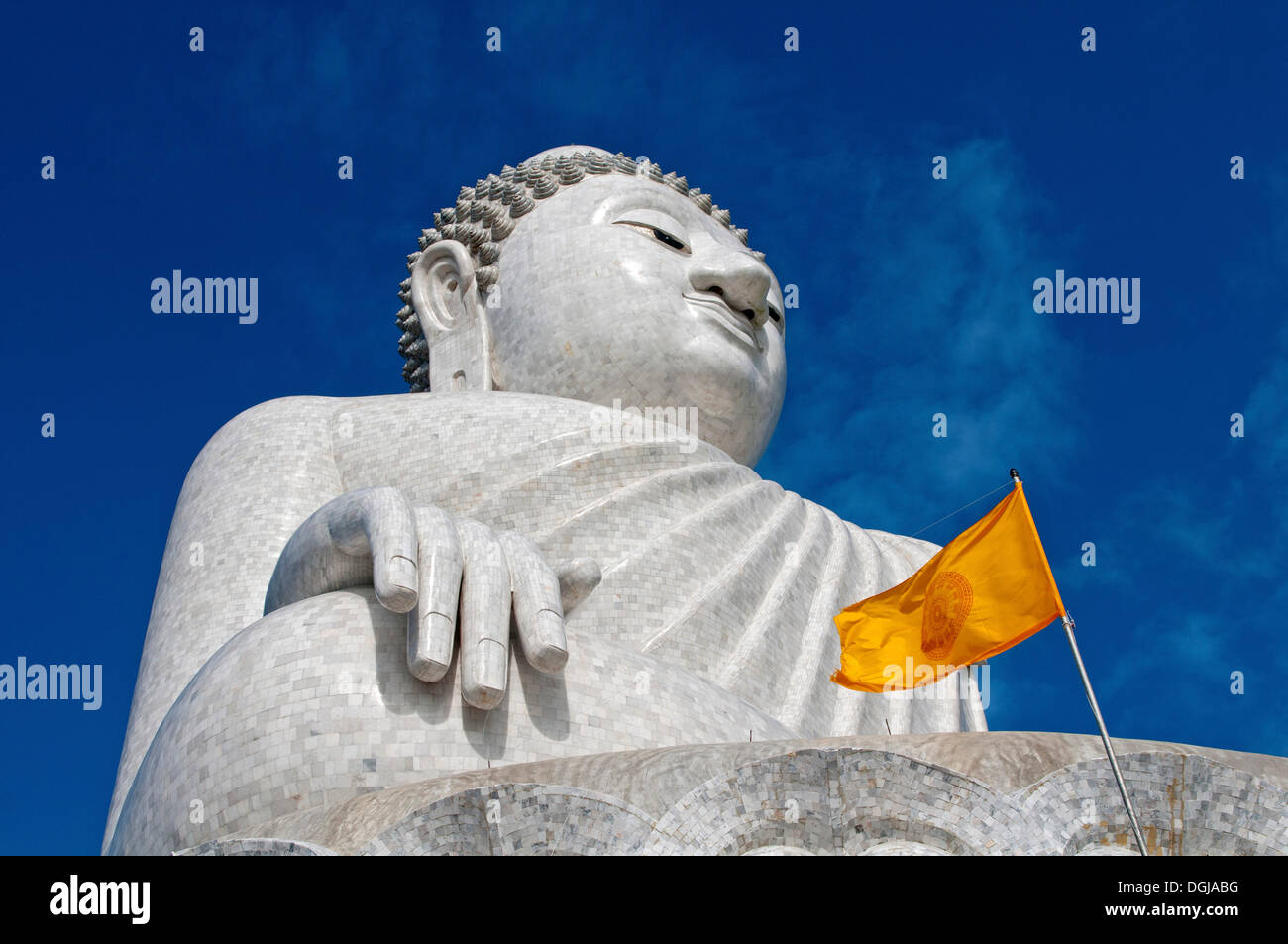 Great Buddha with a yellow Dharmacakra flag, Chalong, Phuket Province, Thailand Stock Photo