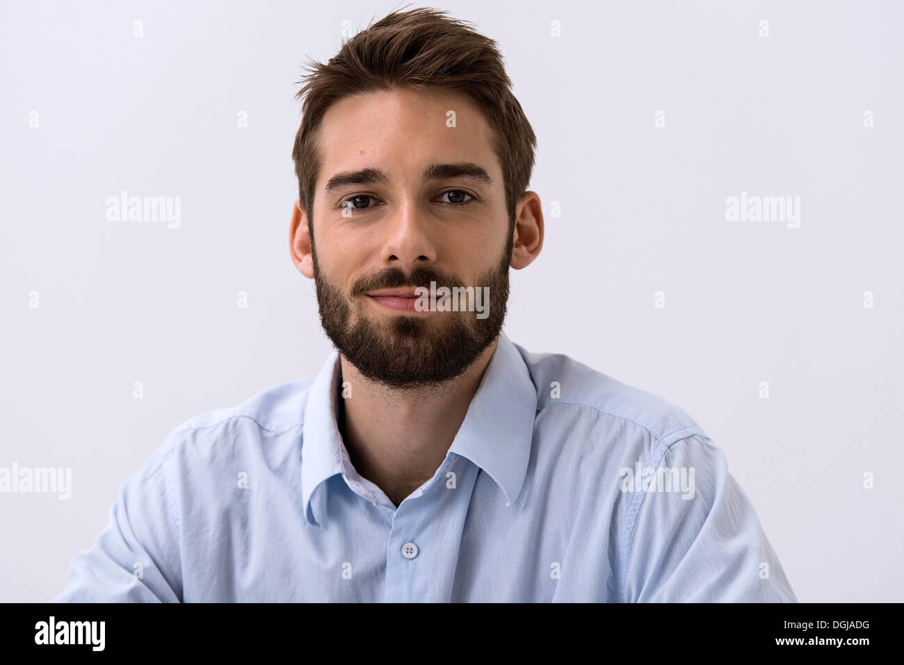 Close up portrait of young man in blue shirt Stock Photo