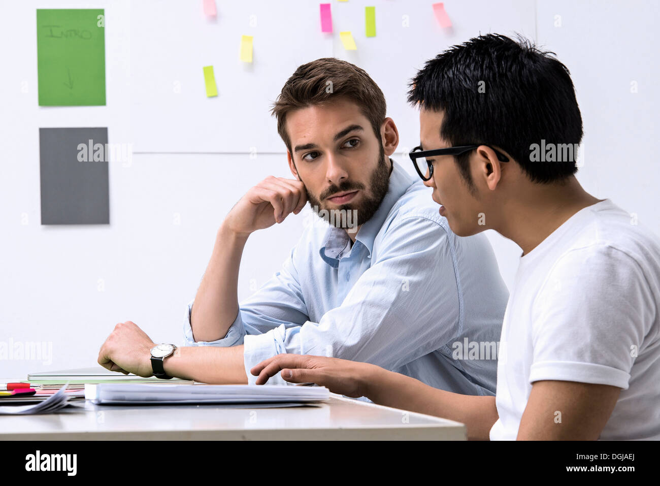 Two young designers discussing ideas Stock Photo