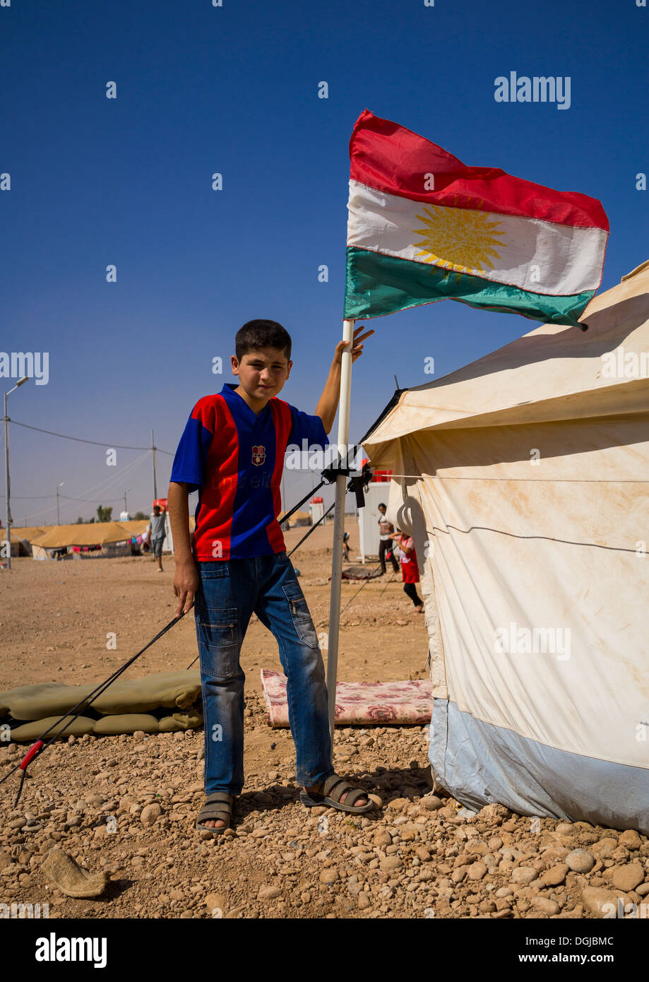 Syrian Refugee Child With A Barcelona Shirt In Front Of His Tent, Erbil, Kurdistan, Iraq Stock Photo