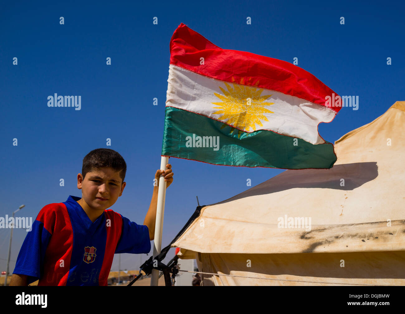 Syrian Refugee Child With A Barcelona Shirt In Front Of His Tent, Erbil, Kurdistan, Iraq Stock Photo