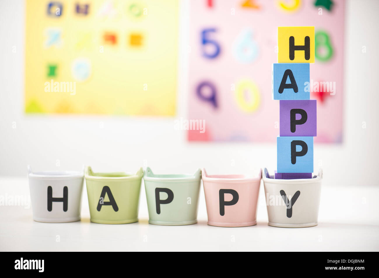cubes and buckets spelling the word happy Stock Photo Alamy