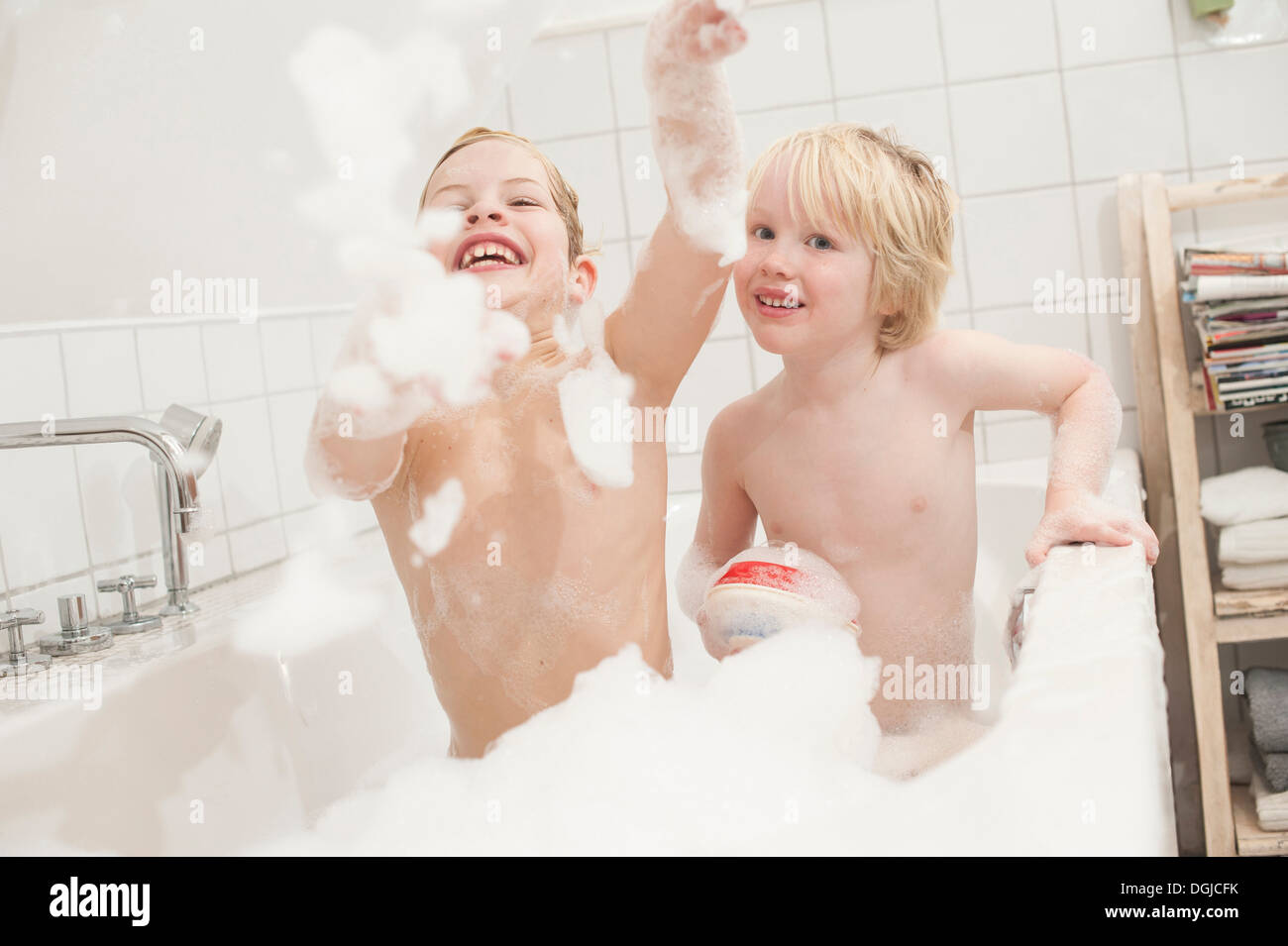 Brothers playing with soapsuds in the bathtub Stock Photo