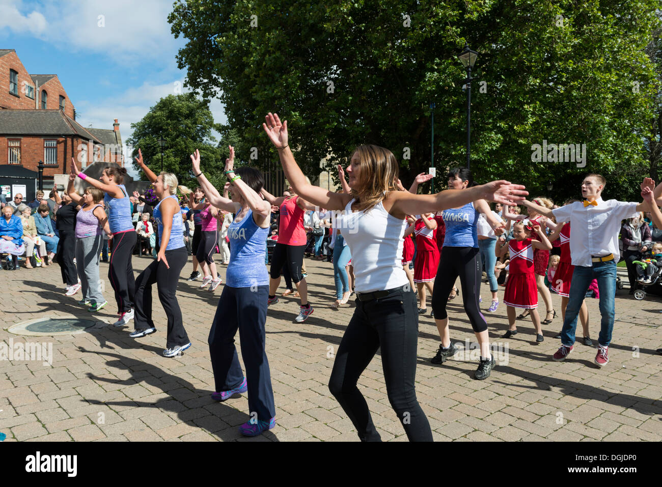 Women dancing on a stage in the open air wearing costumes Dance