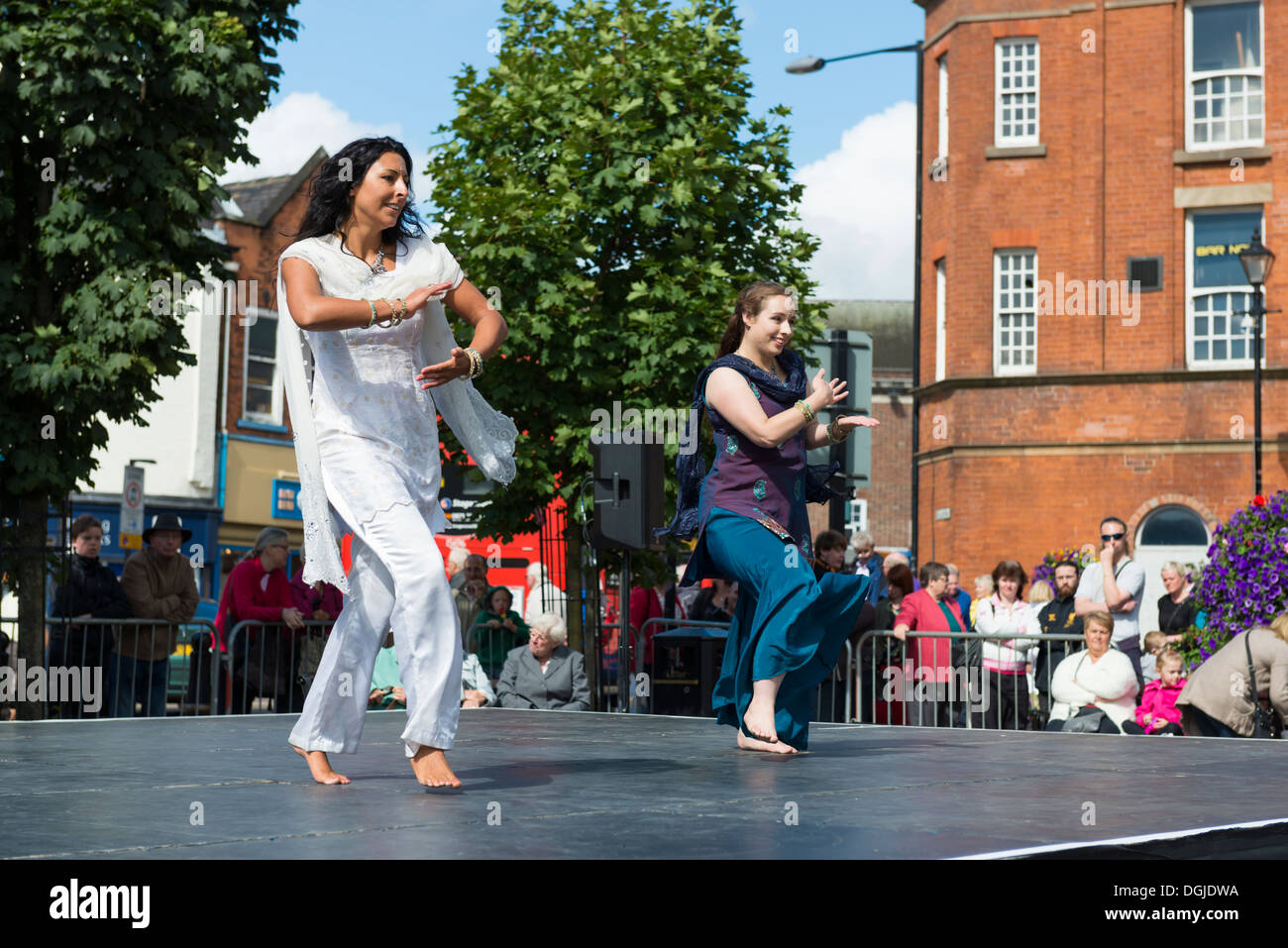 Women dancing on a stage in the open air wearing costumes Dance