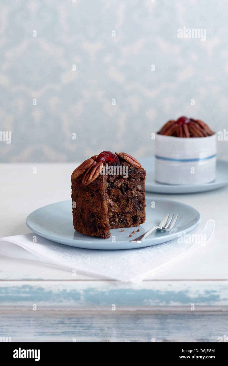Individual fruitcake made with alcohol on plate Stock Photo