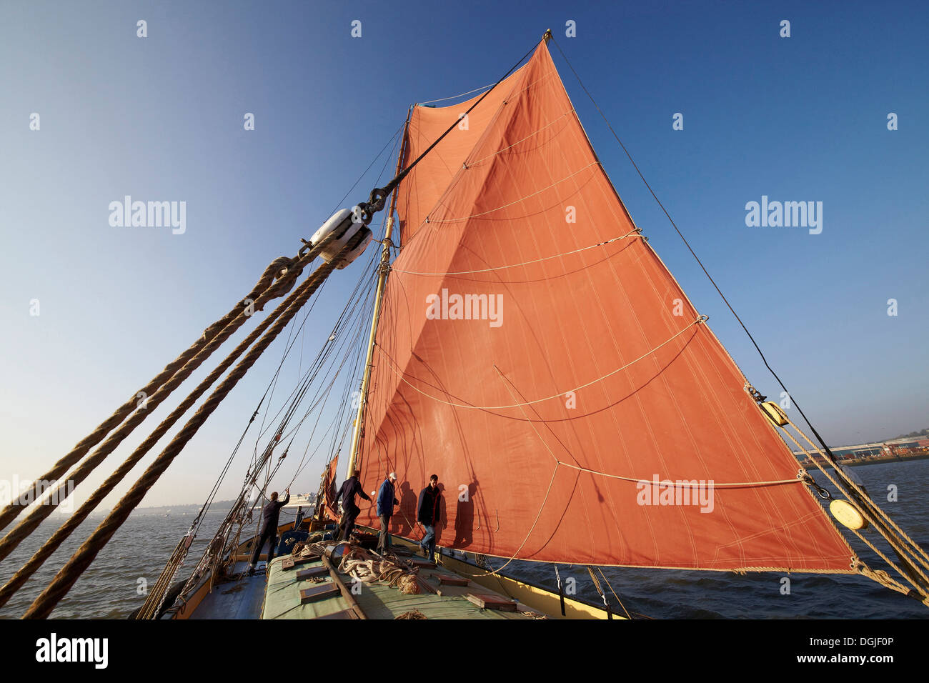 Deckhands work the sails of the Thames sailing barge Edith May while competing in the 2012 Medway Barge Match. Stock Photo