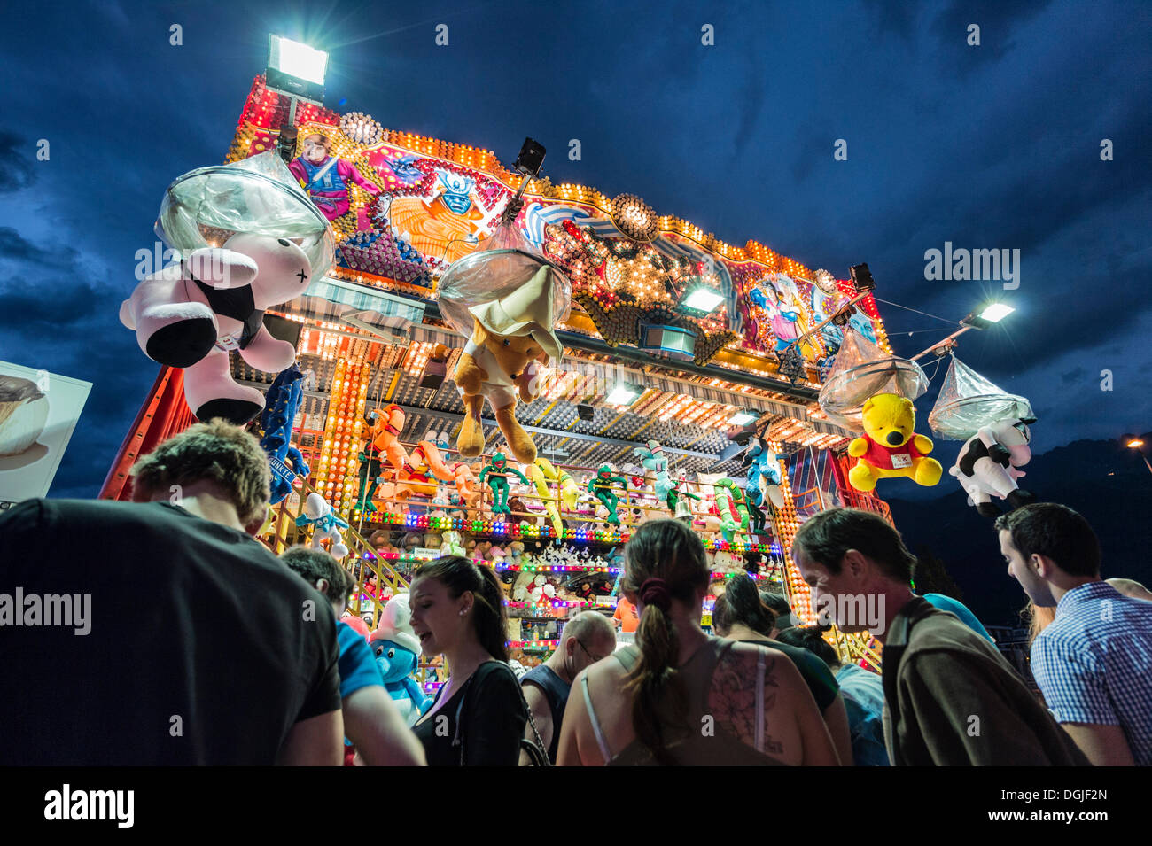 People standing in front of a shooting gallery, Suedring amusement park, Innsbruck, Tyrol, Austria, Europe Stock Photo