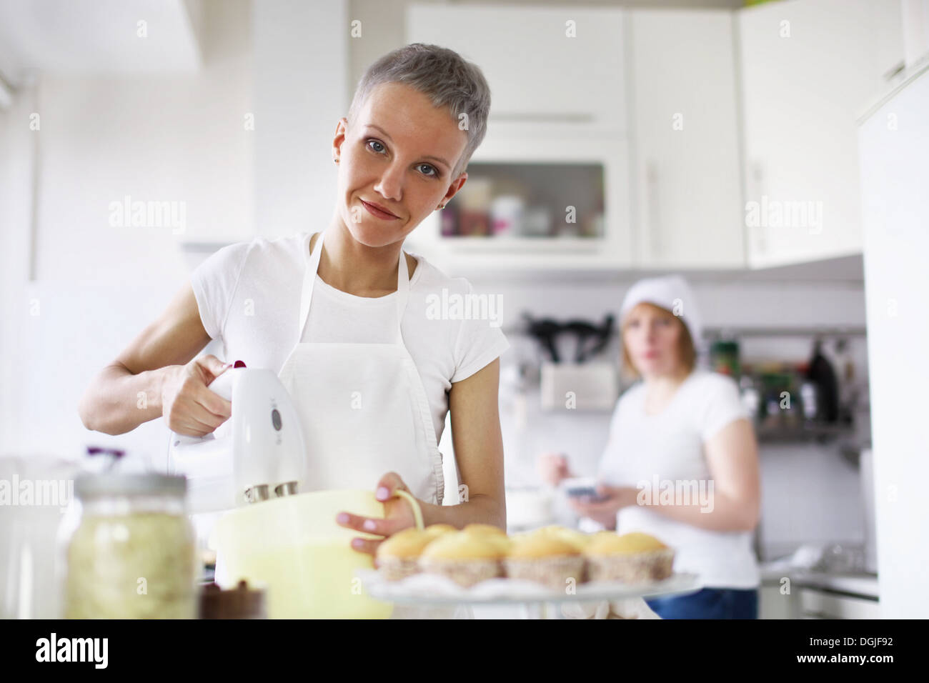 Woman using electric whisk Stock Photo Alamy