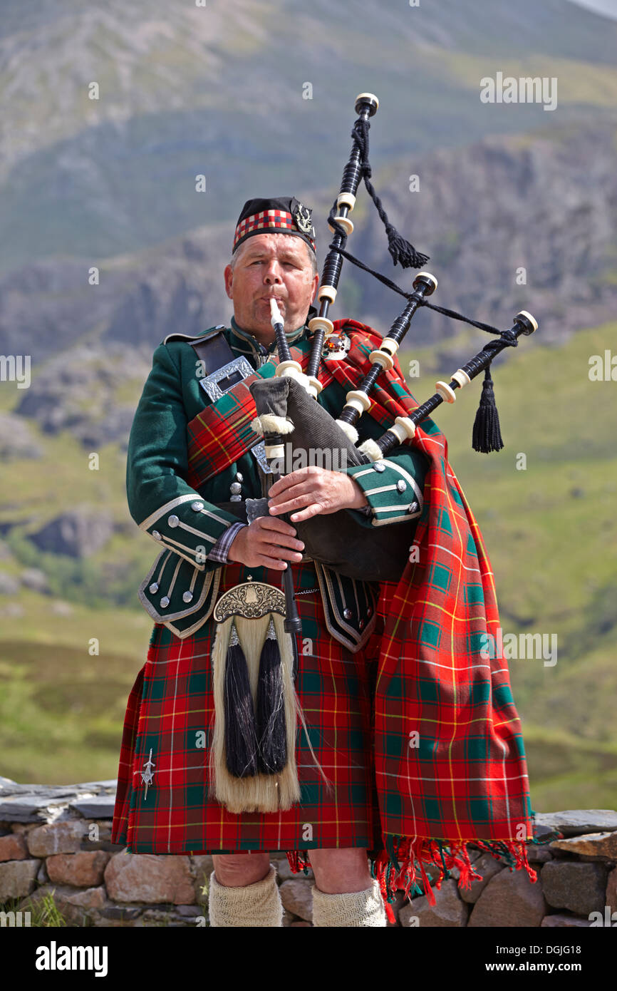 A Scottish piper in Glen Coe. Stock Photo