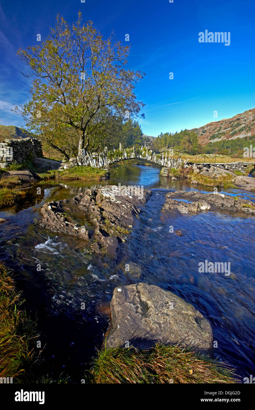 A view of Slater Bridge which crosses the River Brathay on its way from Little Langdale Tarn to Elterwater. Stock Photo
