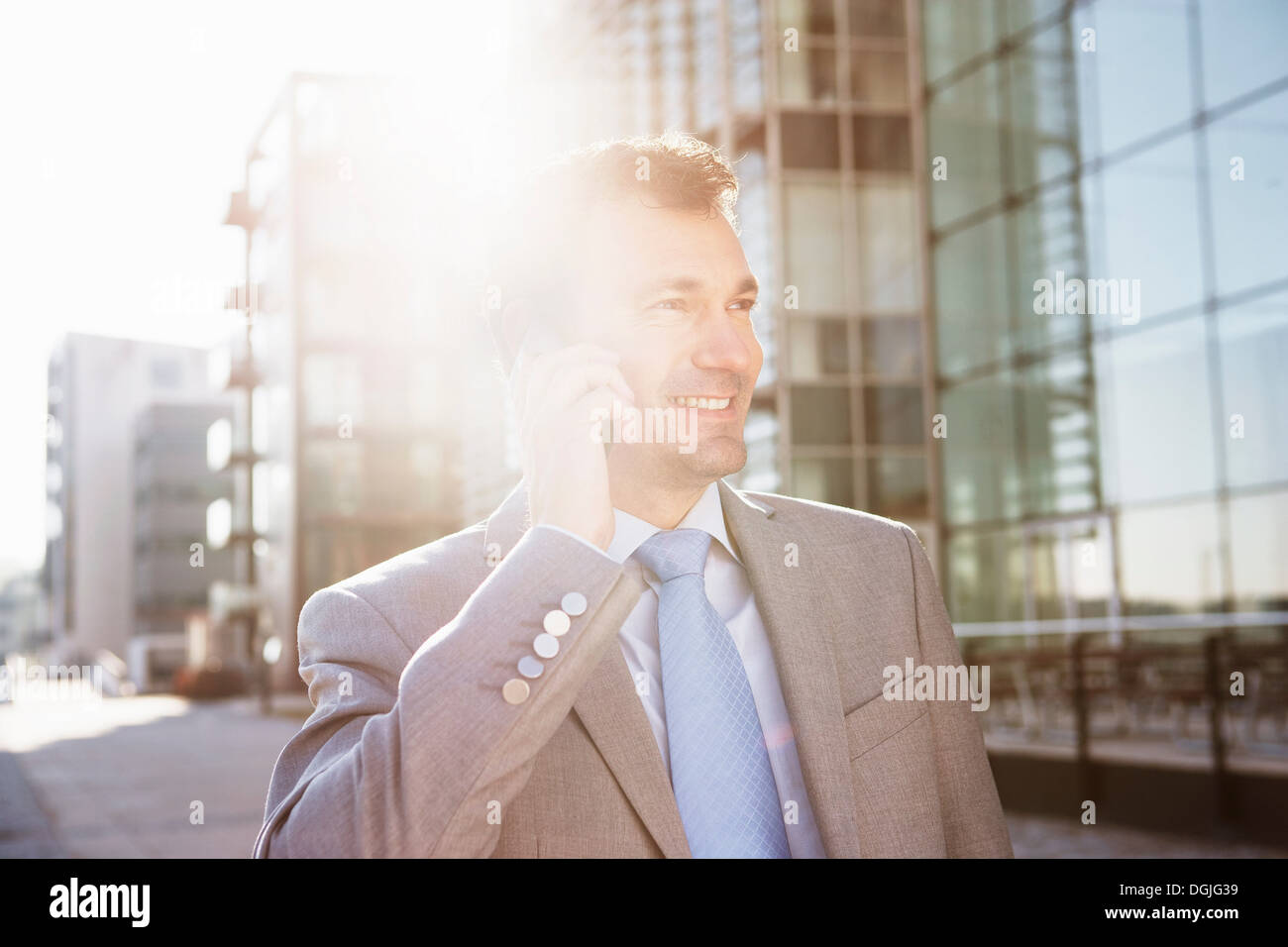 Mature businessman on cellphone in city Stock Photo
