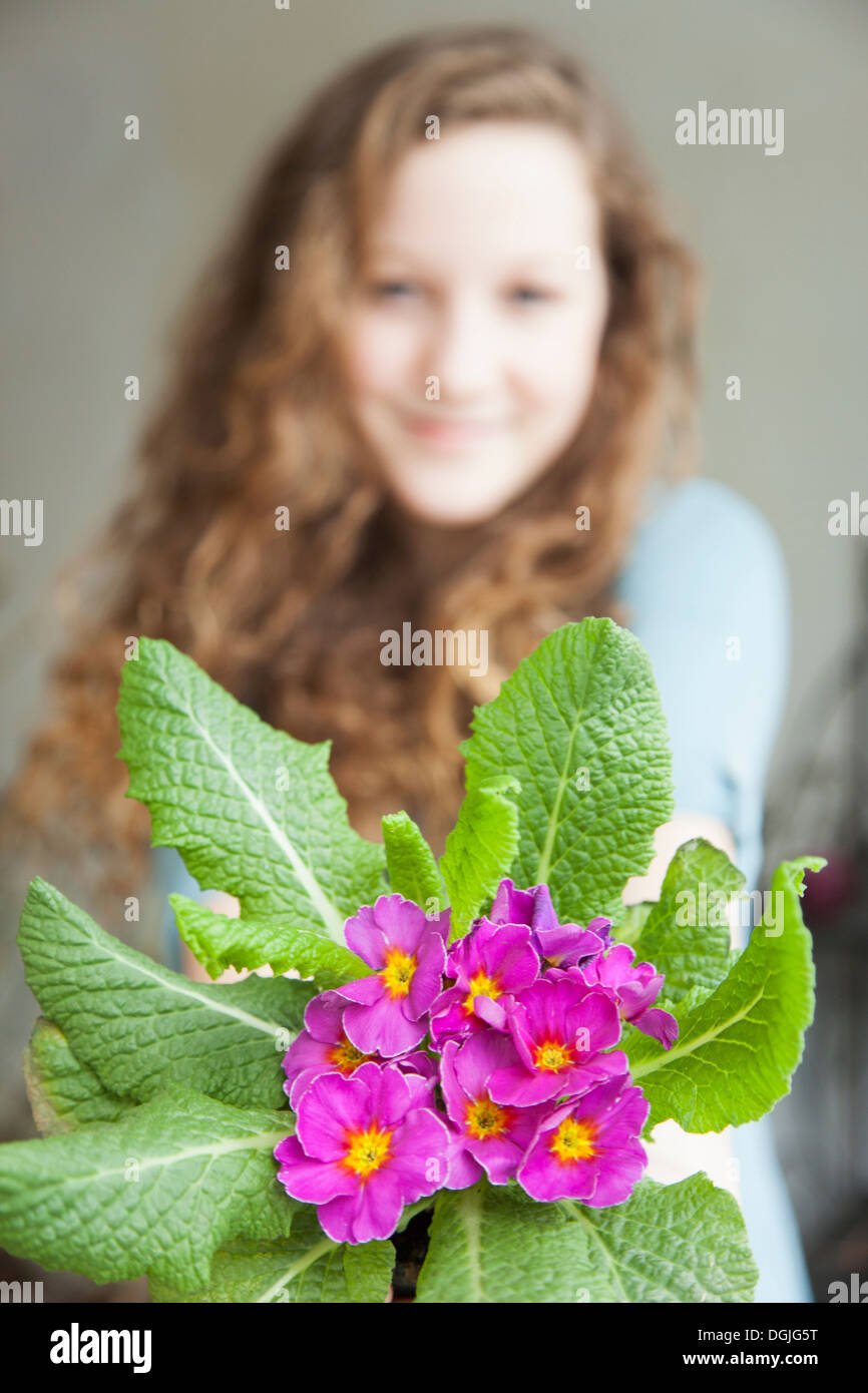 Teenage girl holding flowers, close up Stock Photo
