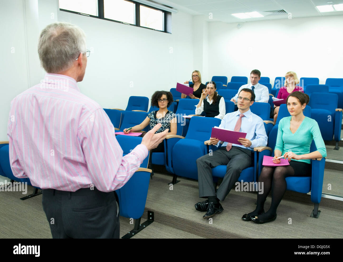 Presenter speaking to group of colleagues Stock Photo