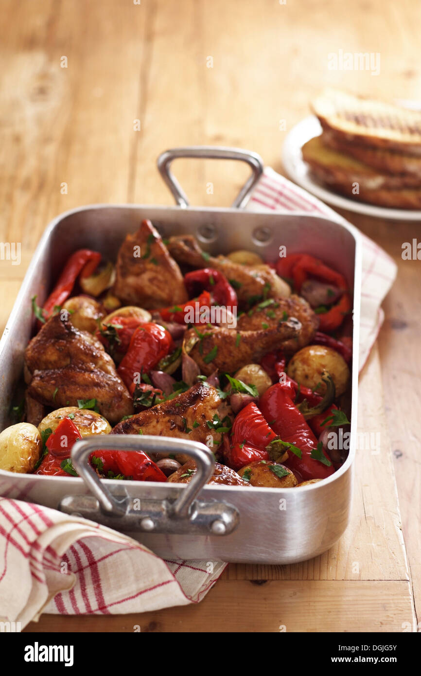 Roast chicken and vegetables in roasting tin Stock Photo Alamy