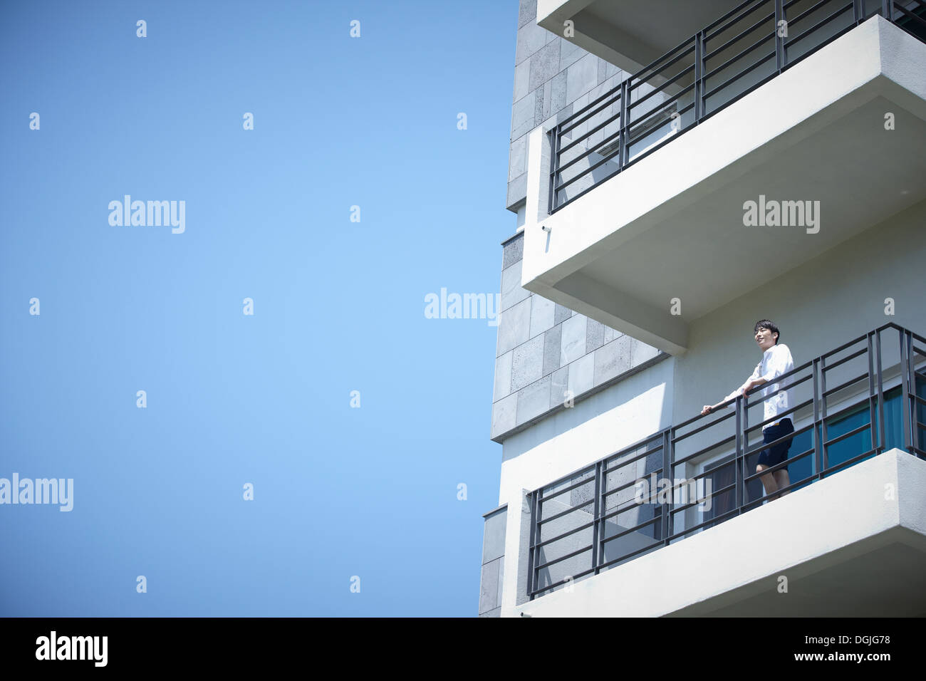 a man standing on a balcony Stock Photo