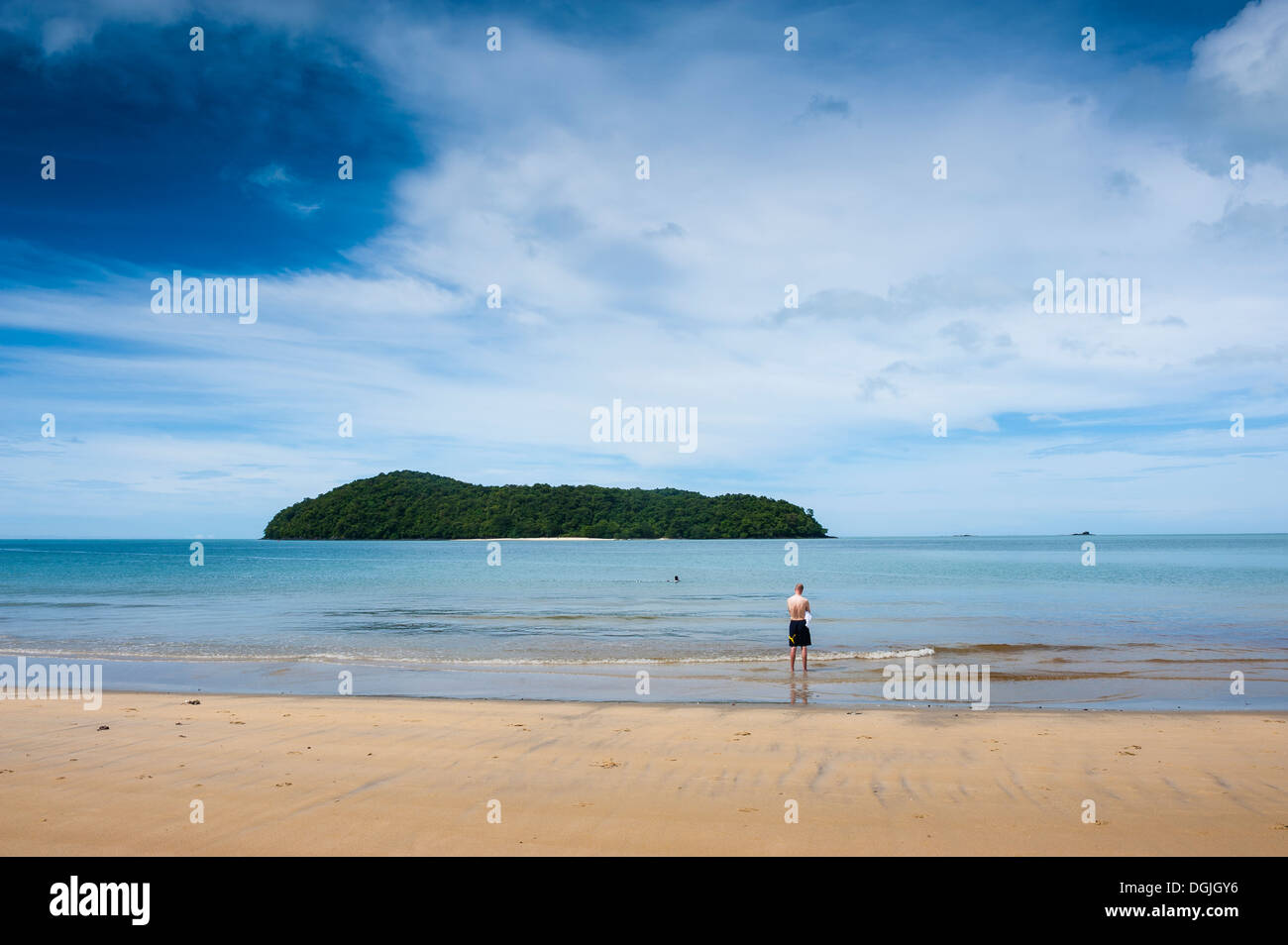 A tourist standing on Pantai tengah beach in Langkawi. Stock Photo