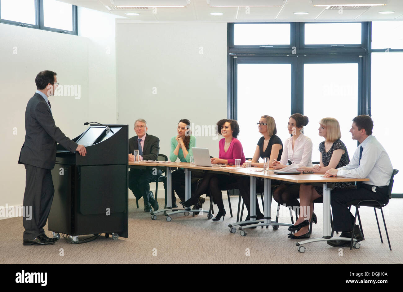 Presenter speaking to group of colleagues Stock Photo