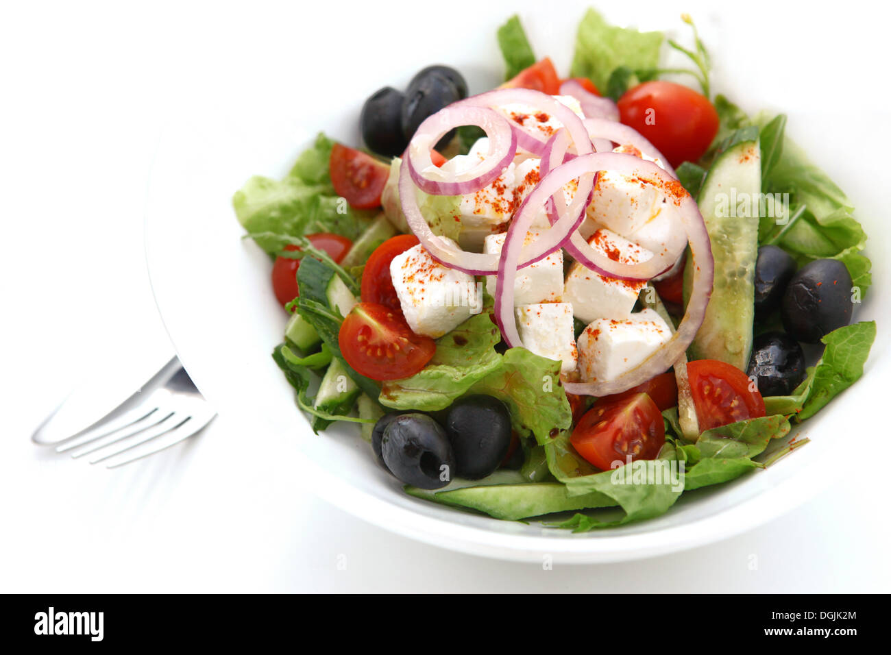 Greek Salad with Feta Cheese tomatoes, cucumbers, lettuce, peppers and black olives Stock Photo