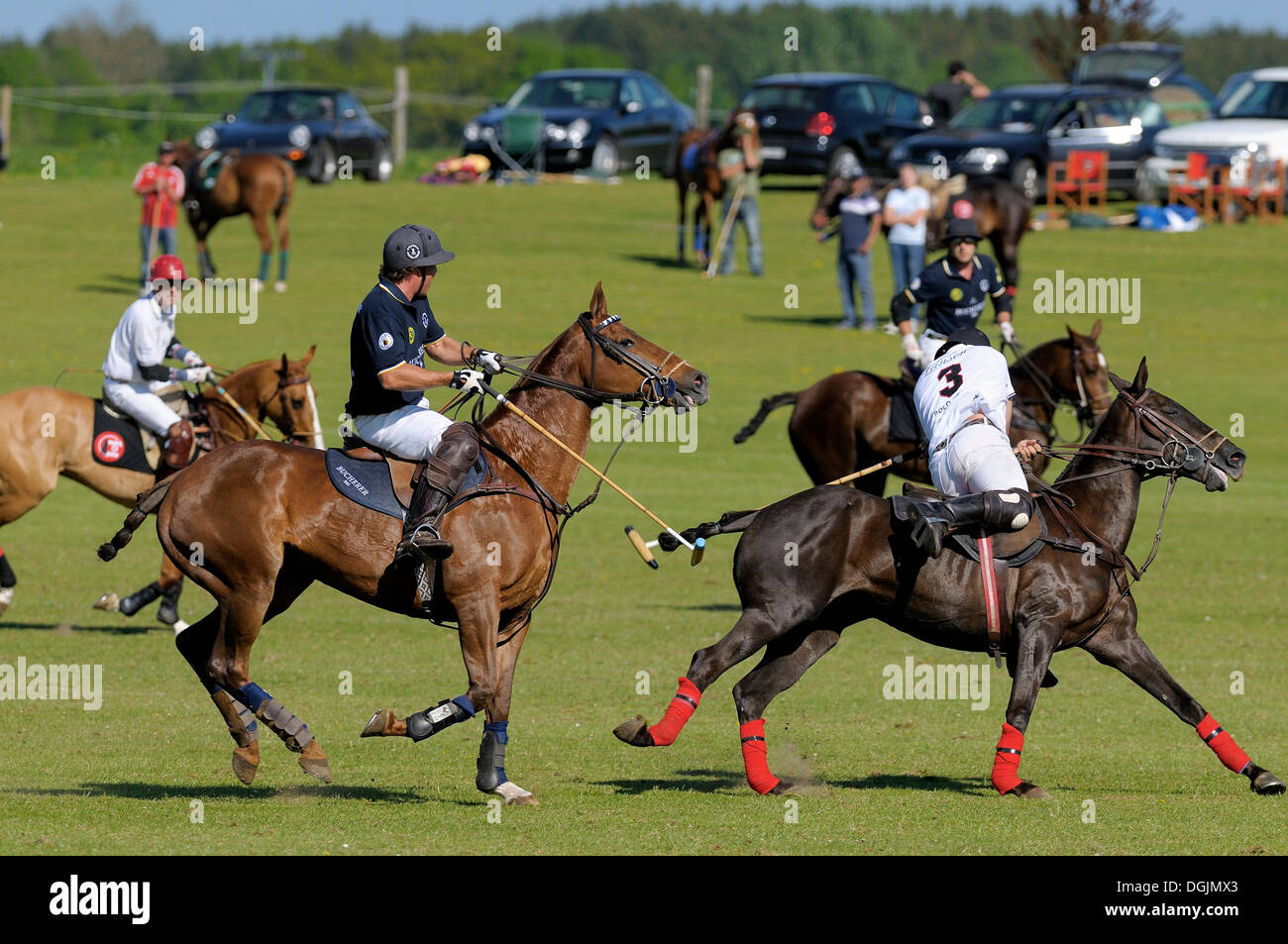 Pedro Llorente, a Team Lanson polo player, wearing a white jersey with the number 3, being chased by Christopher Kirsch Stock Photo