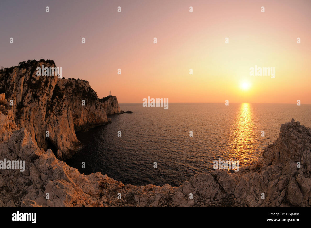Sunset at cape with lighthouse, Lefkas or Lefkada, Greece, Europe Stock Photo