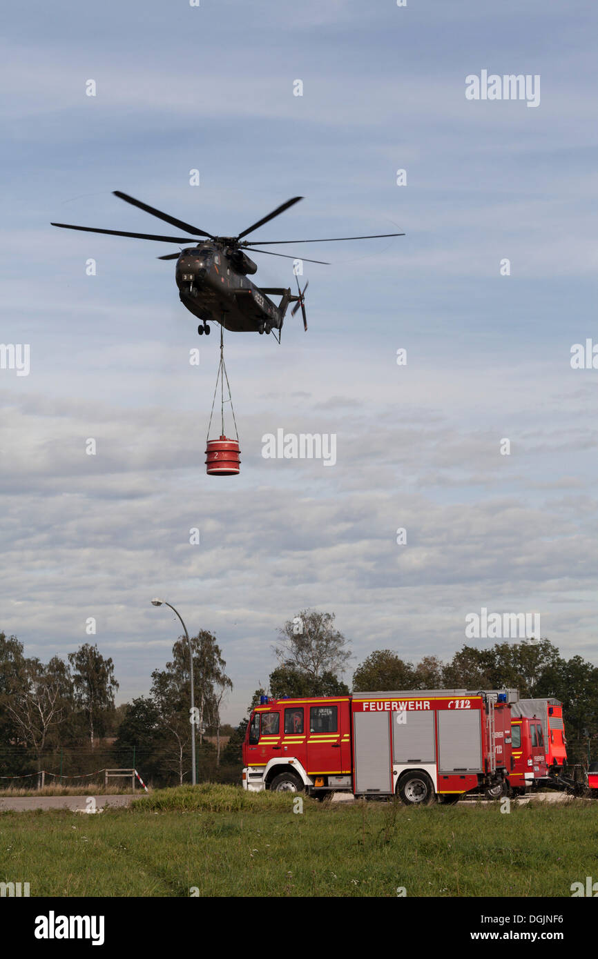 CH53 helicopter carrying a 5000liter water tank during an exercise