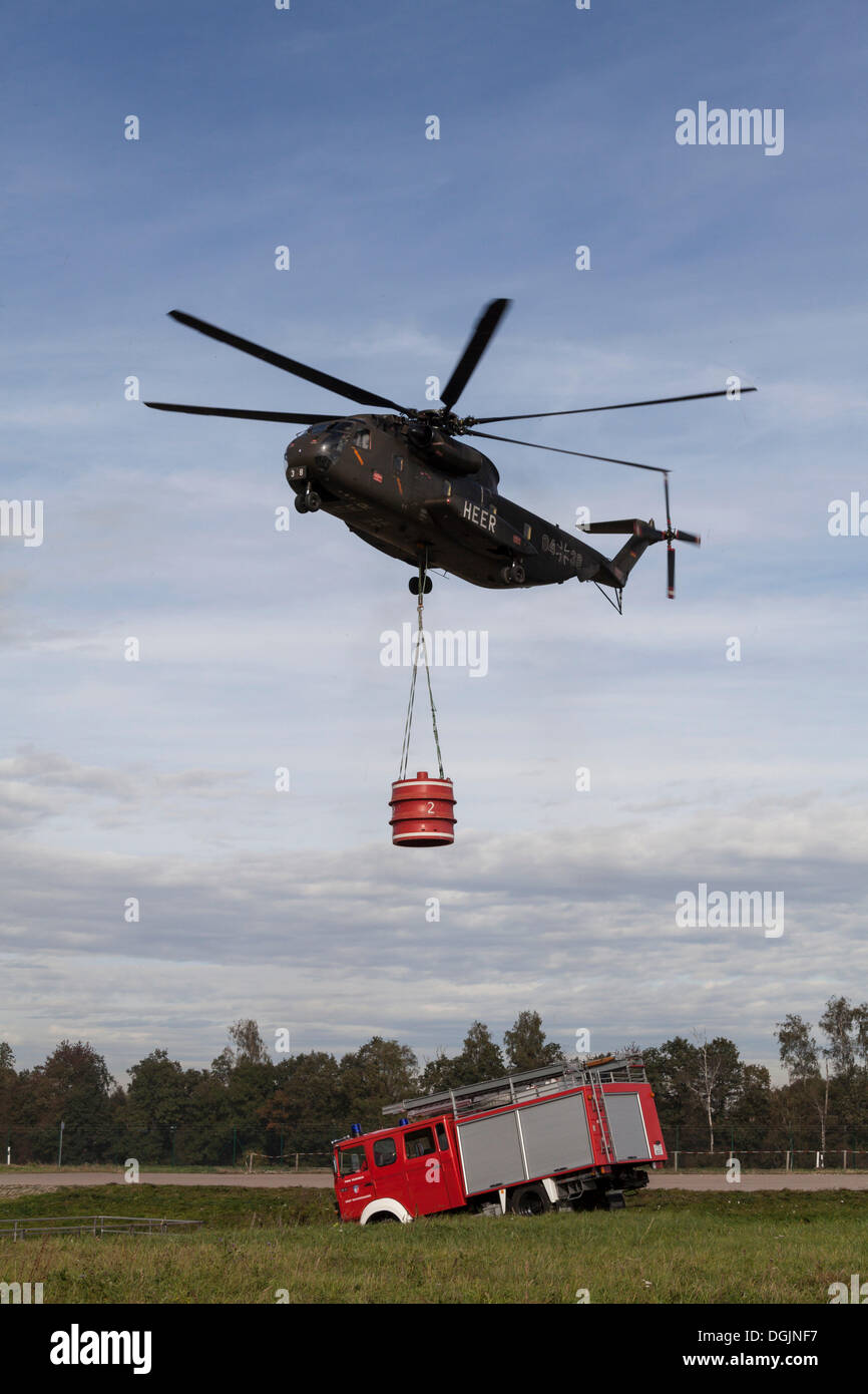 CH53 helicopter carrying a 5000liter water tank during an exercise
